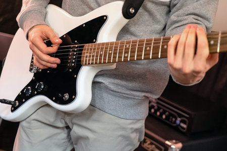 Electric guitar in the hands of a musician close-up. Hands of a guitarist with an electric guitar.