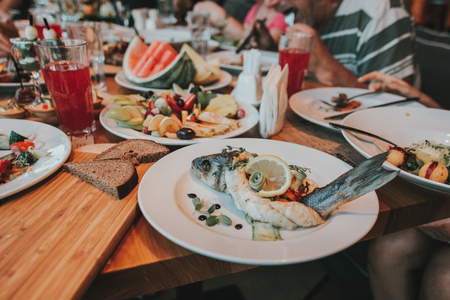 Grilled Fish Fillet with BBQ Vegetables and lemonsの写真素材