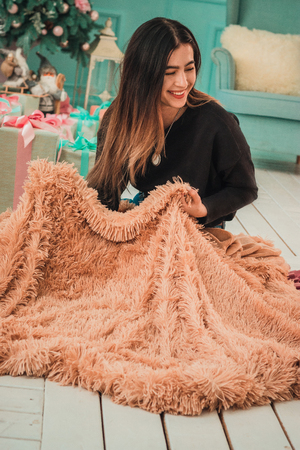 Christmas girl x-mas gift boxes new year, winter december, Smiling happy girl with gift box at decorated furtree, christmas interior and new year decorationの写真素材