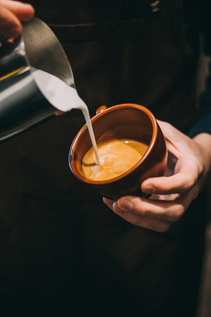 how to make latte art by barista focus in milk and coffeeの写真素材