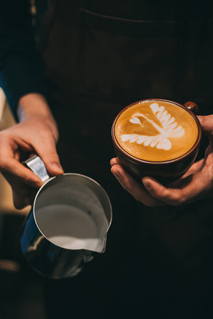 how to make latte art by barista focus in milk and coffeeの写真素材