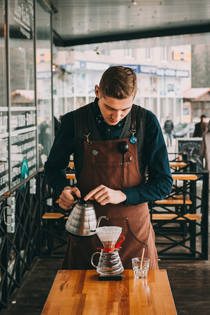 Barista making coffee in coffeeshopの写真素材