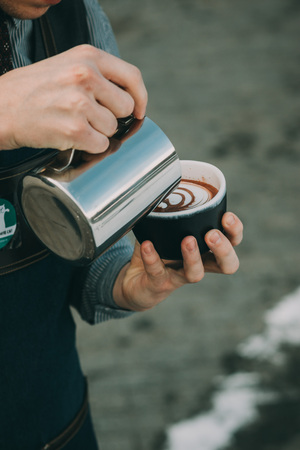 how to make latte art by barista focus in milk and coffeeの写真素材