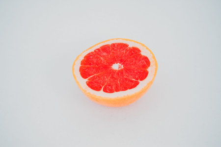 Ripe half of pink grapefruit citrus fruit isolated on white backgroundの写真素材
