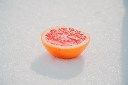 Half of wet juicy grapefruit. Isolated over whiteの写真素材