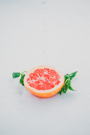 Fresh grapefruit with mint leaves under a rainの写真素材