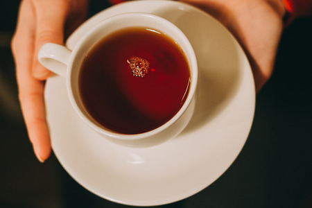Close-up of a woman's hand holding a cup of hot tea. fashion, leisureの写真素材