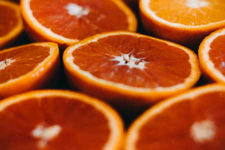 Abstract red background with citrus-fruit of grapefruit slices. Close-up. Backgroundの写真素材