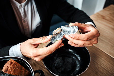 handsome young businessman eating seafood in a luxury restaurant