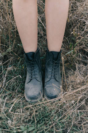 female legs in black boots are very closeの写真素材