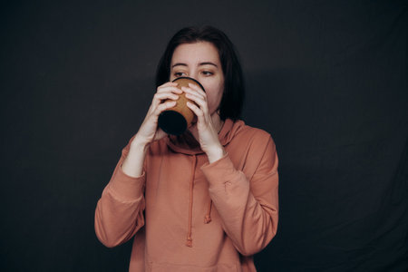 white girl drinks coffee in studio