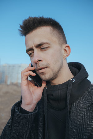 Young white caucasian man talking by the phoneの写真素材