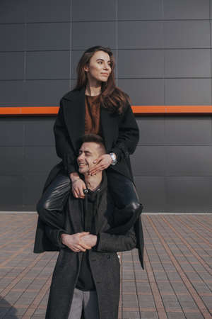 Young loving couple with coffee on black backgroundの写真素材