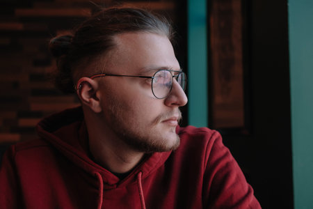 Portrait of happy male freelancer in optical eyewear for vision correction smiling at camera during...