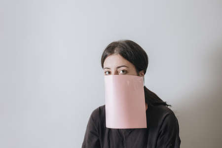Beautiful asian woman applying paper sheet mask on her face whiteの写真素材