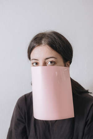 Beautiful asian woman applying paper sheet mask on her face whiteの写真素材