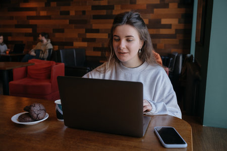 freelance woman happy working in a cafe remotelyの写真素材
