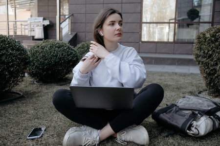 Workation outdoor. Woman working on laptop in park. Distant remote job work during quarantine virus