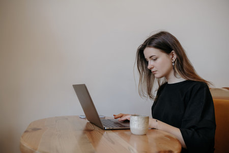 freelance woman happy working in a cafe remotely