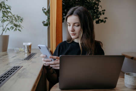 freelance woman happy working in a cafe remotelyの写真素材