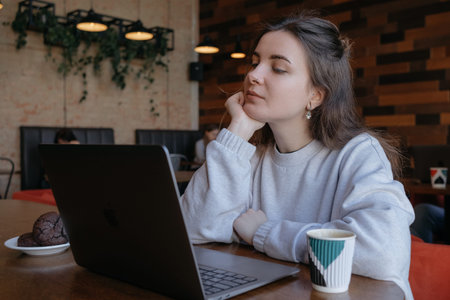 freelance woman happy working in a cafe remotely