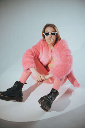 Fashion model in pink suit and sunglasses. Studio shot. Film editの写真素材