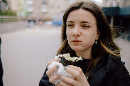 LGBT Lesbian woman eat sushi rolls on the walk asian cafe. streetの写真素材