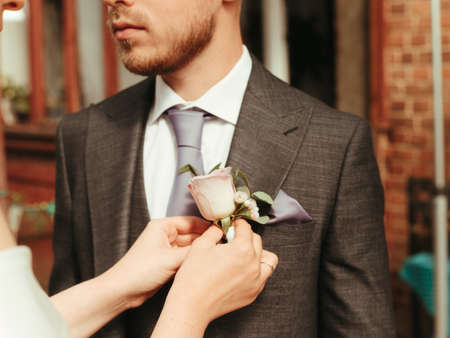 bride helps groom to wear a tie grain effectの写真素材