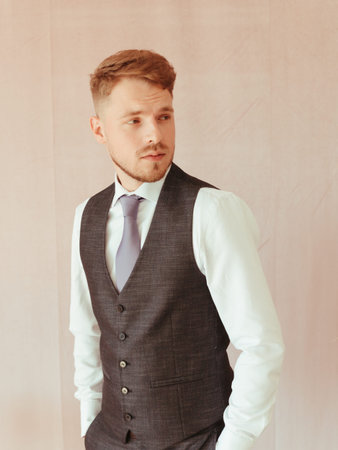 fashion young man wearing black tuxedo, grain effect studio blond