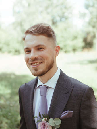 fashion young man wearing black tuxedo, grain effect studio blondの写真素材
