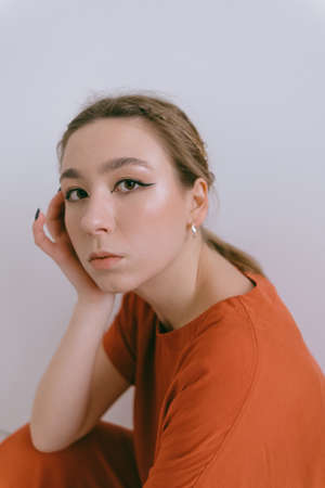 Portrait of young caucasian woman in red cloth.の写真素材