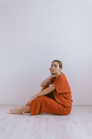 Portrait of young caucasian woman in red cloth.の写真素材