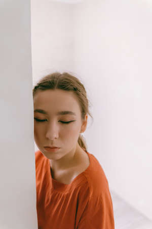 Portrait of young caucasian woman in red cloth.の写真素材