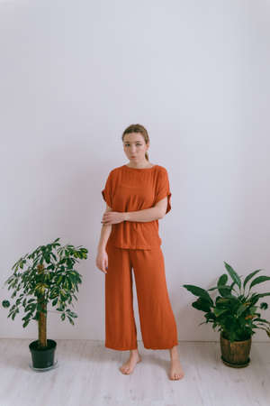 Portrait of young caucasian woman in red cloth.の写真素材