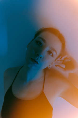 portrait of a young woman with spot lightの写真素材