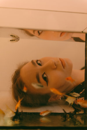 porrait of woman underwater with fish conceptの写真素材