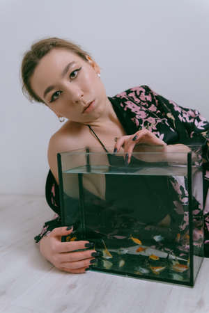aquarium with young pretty womanの写真素材
