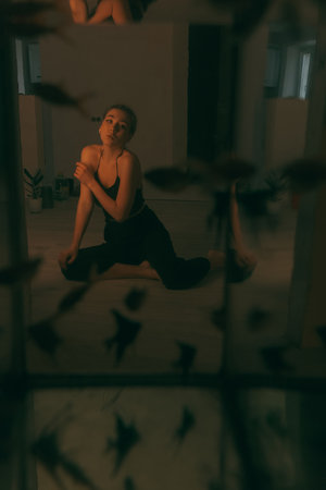 portrait of woman at home during renovation. dark. spot light on the modelの写真素材