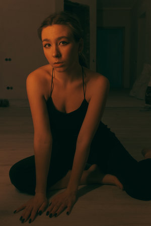 portrait of woman at home during renovation. dark. spot light on the modelの写真素材
