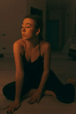 portrait of woman at home during renovation. dark. spot light on the modelの写真素材