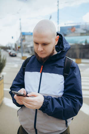 Young irish man smiling happy using smartphone at the city. mapsの写真素材