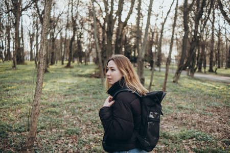 woman traveler with backpack and looking at amazing forest, wanderlust travel concept, space for text, atmospheric epic momentの写真素材