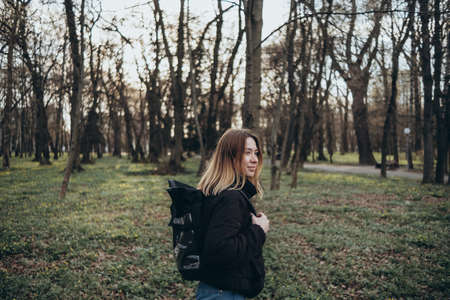 woman traveler with backpack and looking at amazing forest, wanderlust travel concept, space for text, atmospheric epic momentの写真素材