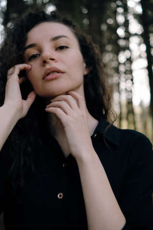 portrait of curly brunette woman in the park close upの写真素材