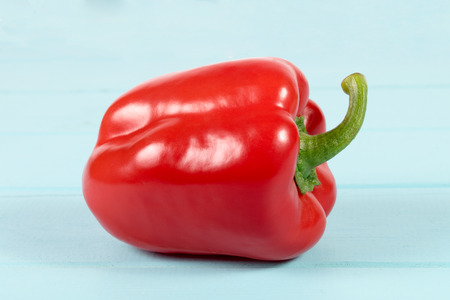 the whole red sweet bulgarian pepper isolated on blue wooden backgroundの写真素材