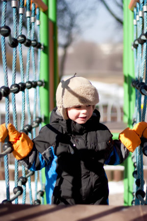  boy  on the winter pleasure-ground in park
