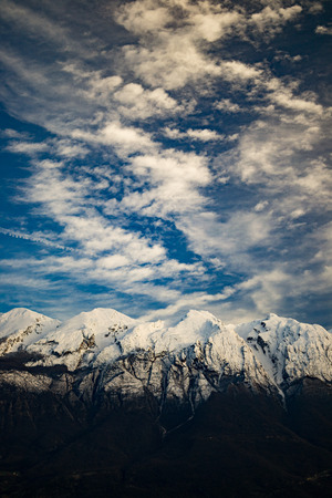Snow covered mountain peaks in Italy near Garda lake.の写真素材