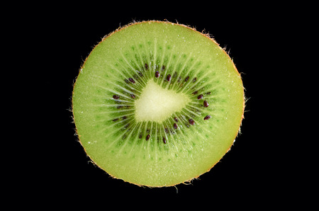 Slice of kiwi on black background. Closeupの写真素材