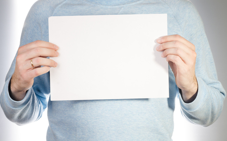 A married man holding white blank billboard.の写真素材