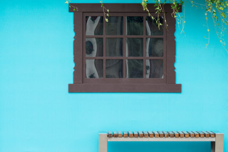 View from the front of the wooden brown window on the blue house